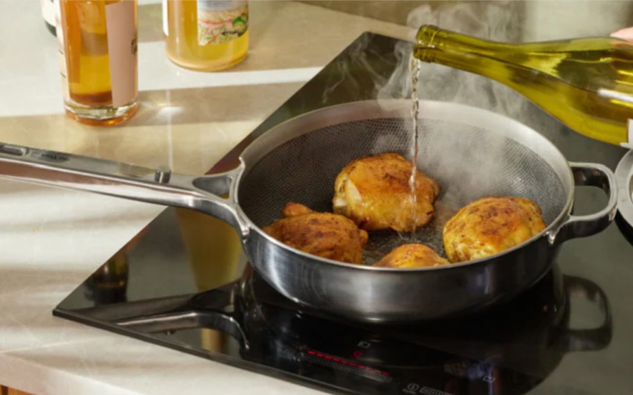 pouring oil into titanium pan on stove