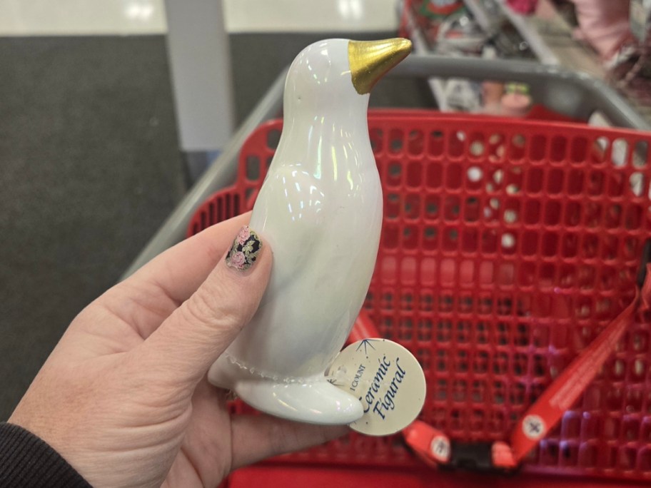 hand holding penguin figure 