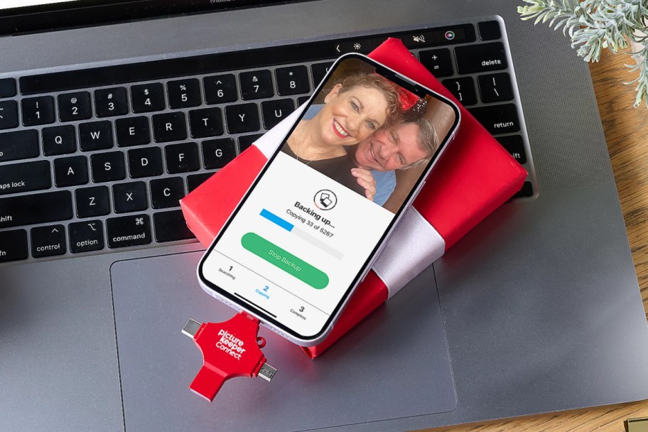 phone sitting on top of red gift box on laptop