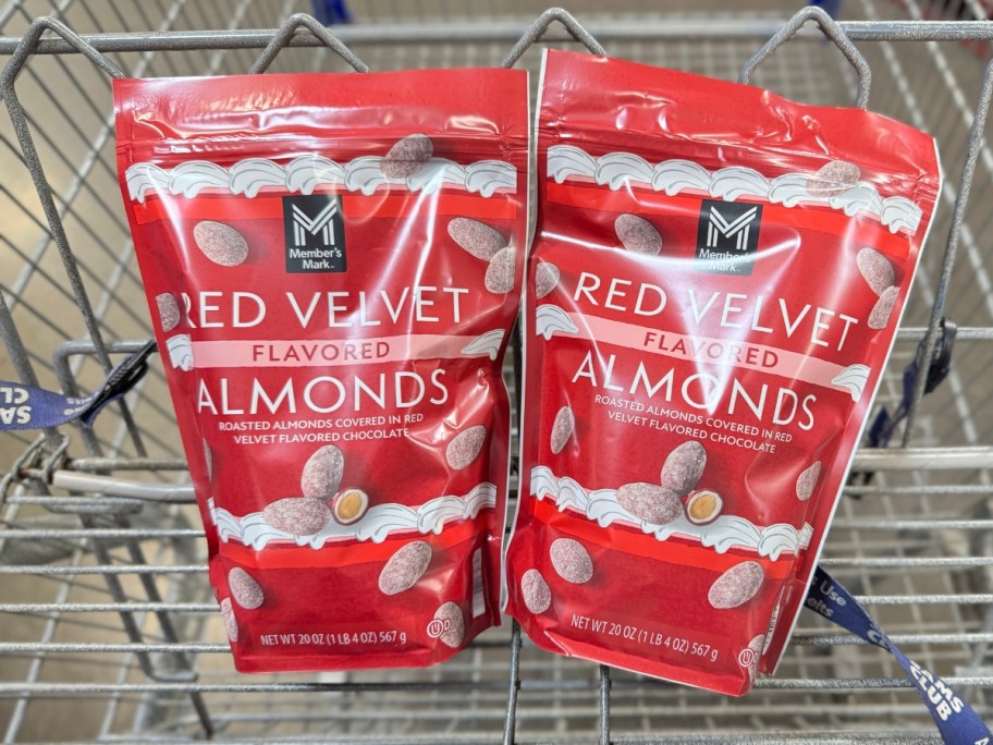 2 red and white bags of Member's Mark Red Velvet Almonds in a Sam's Club cart