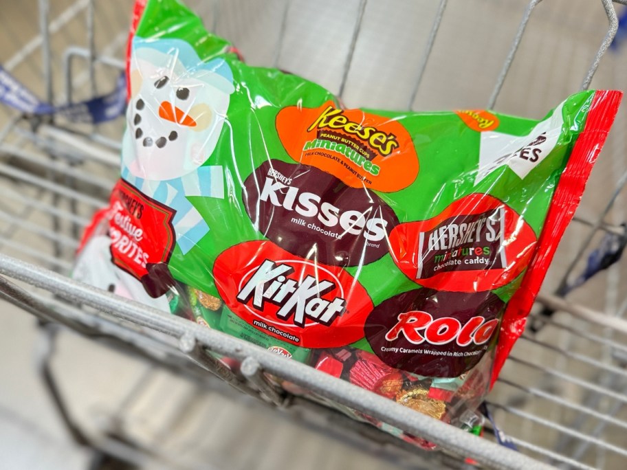 a large bag of Hershey's Festive Favorites Chocolate Candy with a snowman on it in a Sam's Club cart