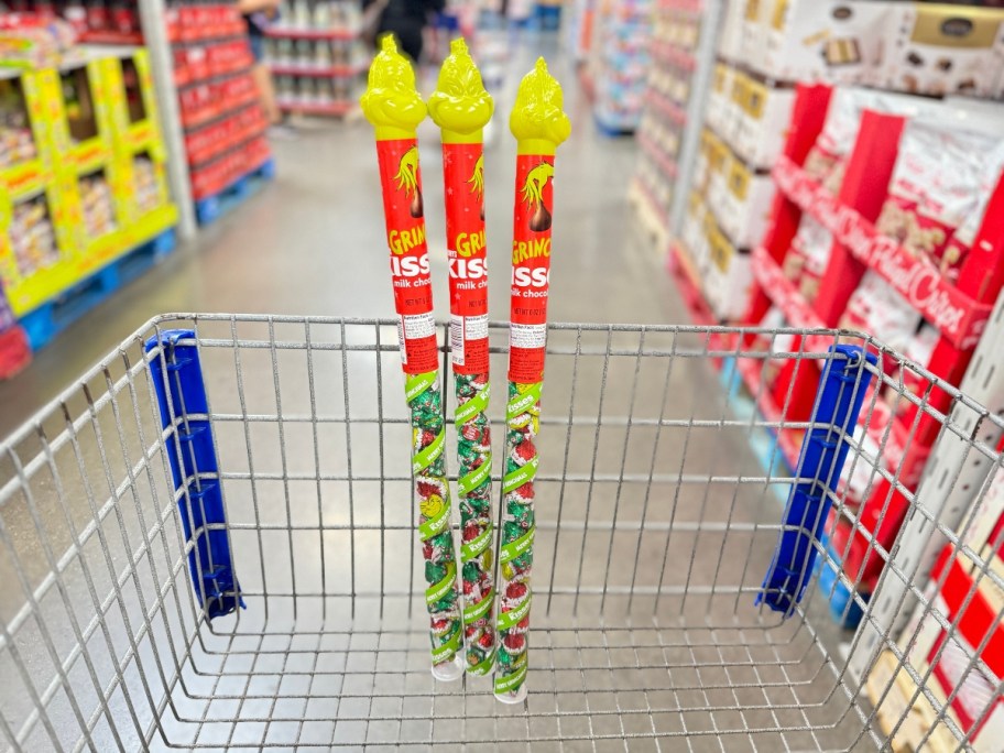 sam's club cart with 3 plastic tube shaped containers with the Grinch head on them filled with Hershey Kisses