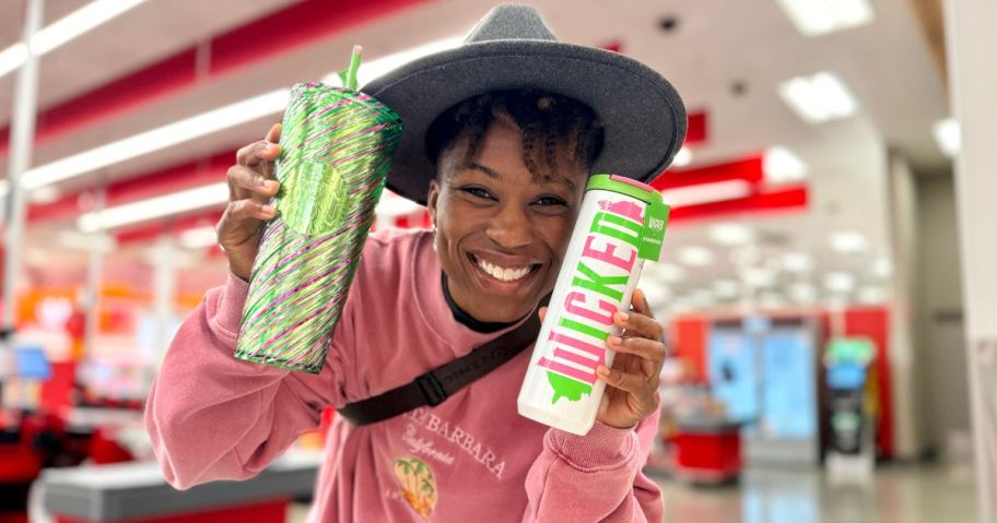 girl holding starbucks wicked cups in store