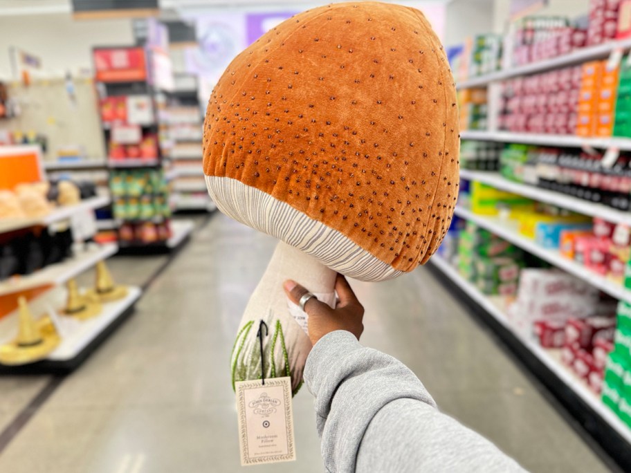 hand holding orange mushroom plush 