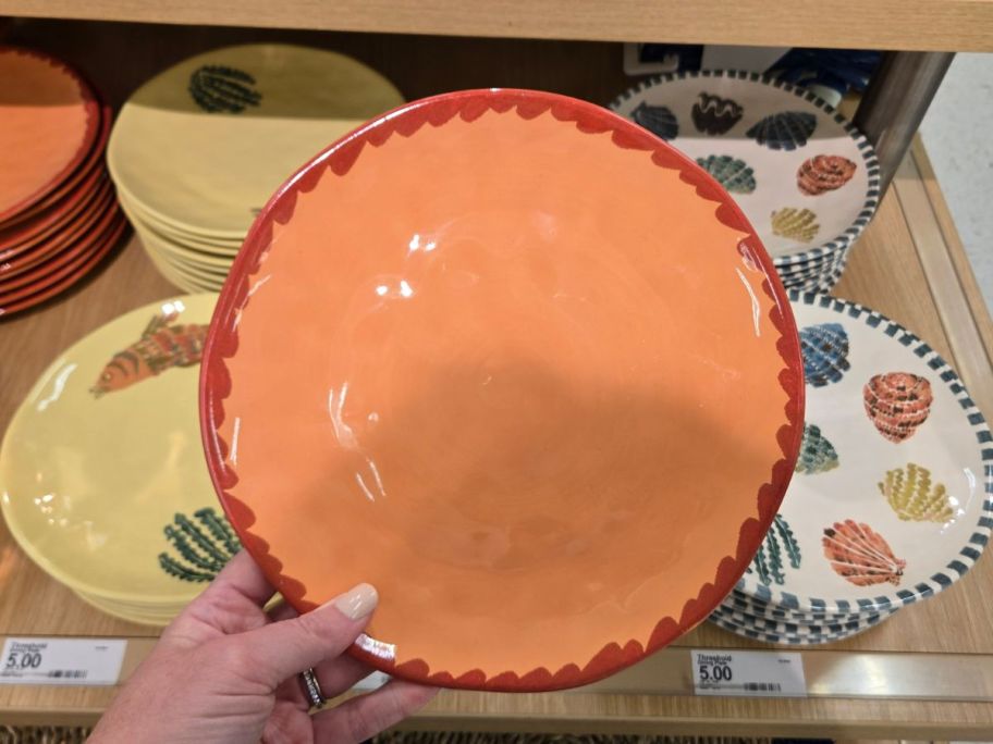 peach colored Threshold 9" Stoneware Dinner Plate in hand in store