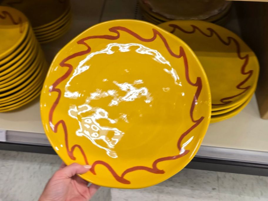 yellow and orange Threshold 12.5" Round Serving Platter in hand in store