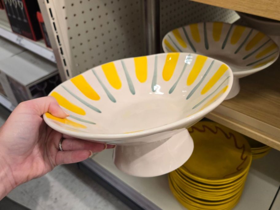 white, blue, and yellow Threshold Pedestal Serving Bowl in hand in store