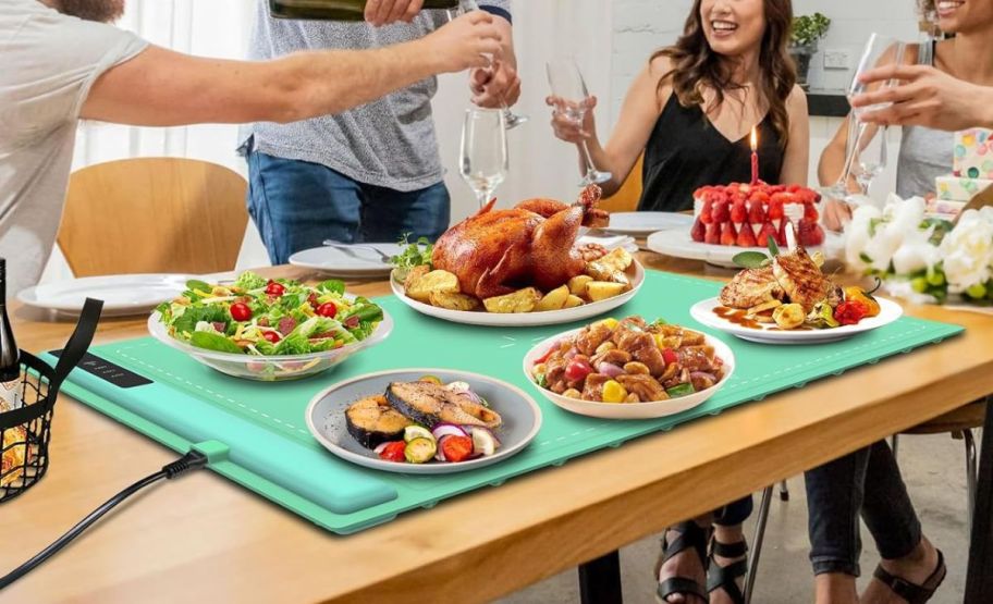 a food warming tray on a dining table shown with various dishes 