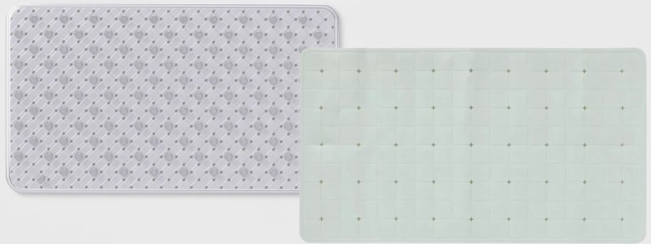 a clear shower mat and a light green bath mat