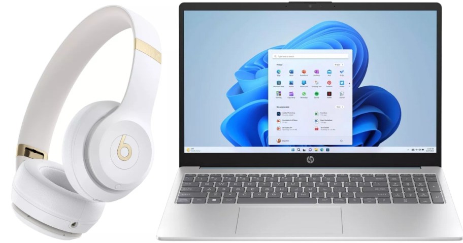 a white and gold pair of Beats headphones and a silver HP Laptop open showing the screen