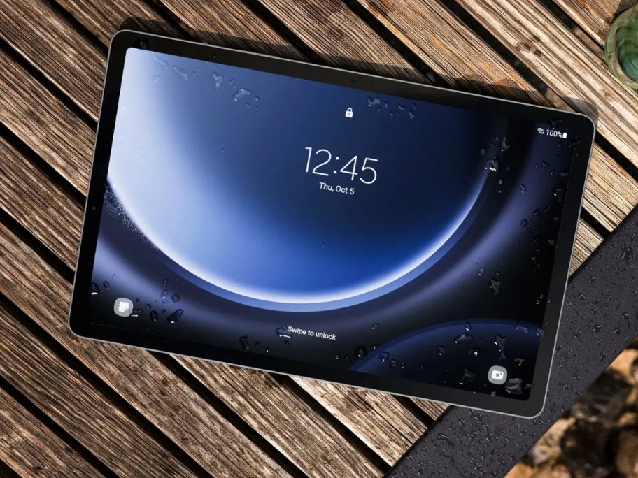 a Samsung Galaxy tablet laying on a wood top table