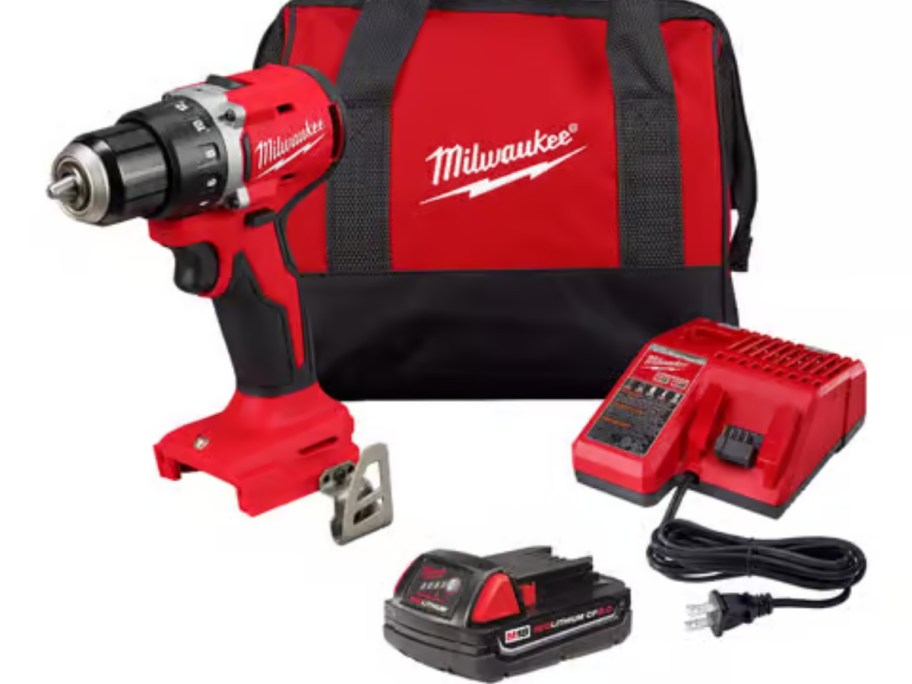 a red and black Milwaukee drill, battery, charger and bag