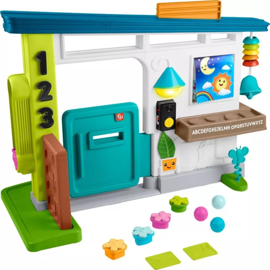 a kid's toy Playhouse with various interactive toys, a door, mailbox, numbers and more on it