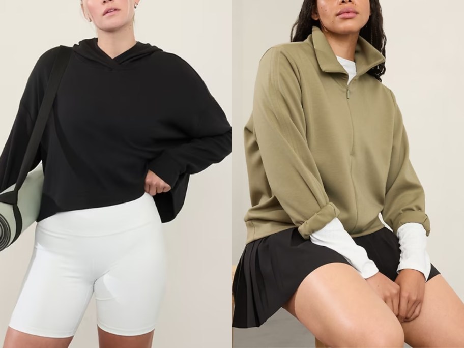 woman wearing a black hoodie with white bike shorts and woman wearing a moss green quarter zip pullover with a black skirt