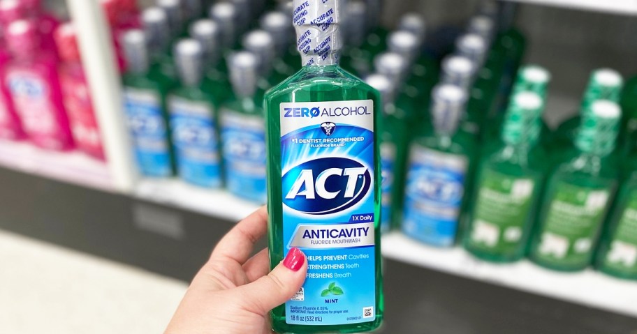 hand holding up a green bottle of ACT Zero Alcohol Mouthwash