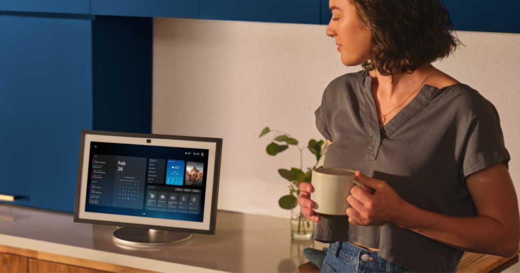 Woman, looking at her Alexa device on a countertop