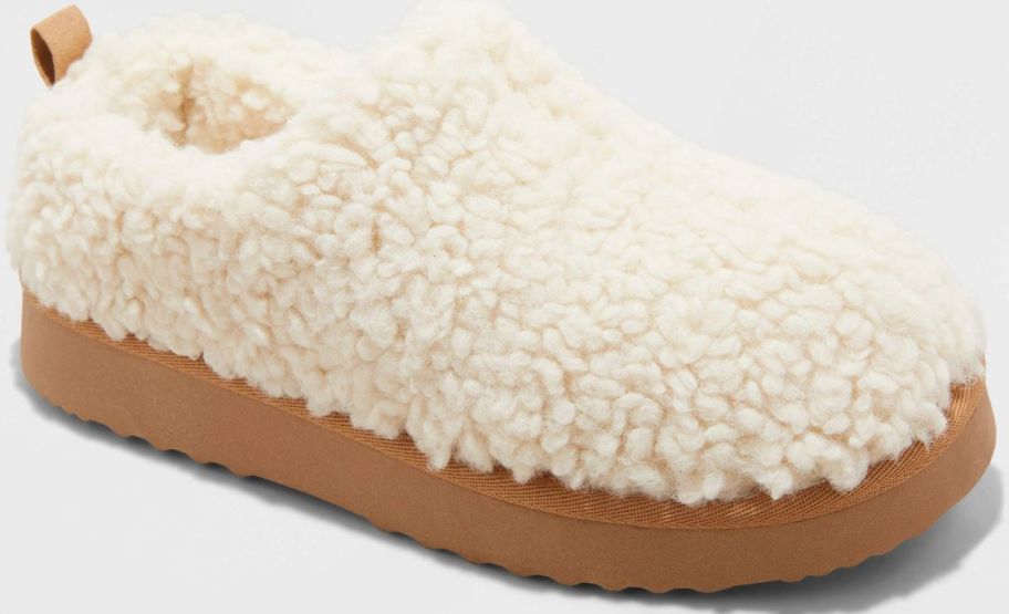 cream colored faux sherling womans slipper stock image