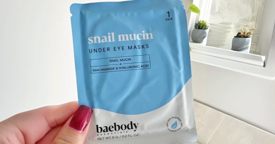 hand holding up a pack of Baebody Snail Mucin Under Eye Masks