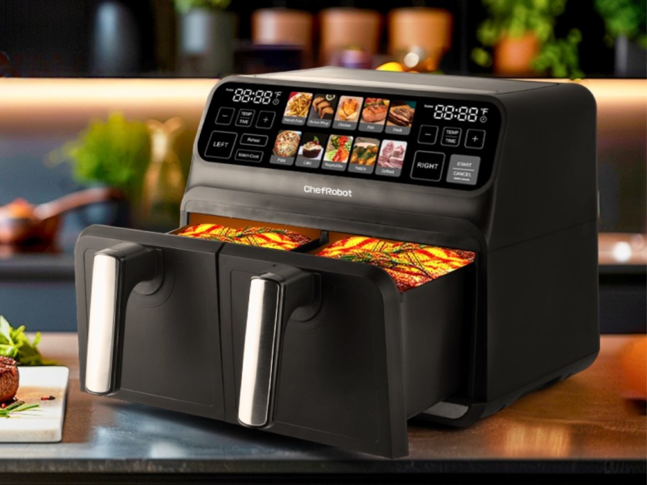 a black and silver dual basket large air fryer with a visual touch display on a counter with food in it