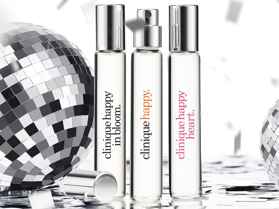 three travel size clinique perfumes near disco ball