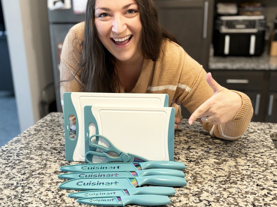 woman pointing to a knife and cutting board set on kitchen counter