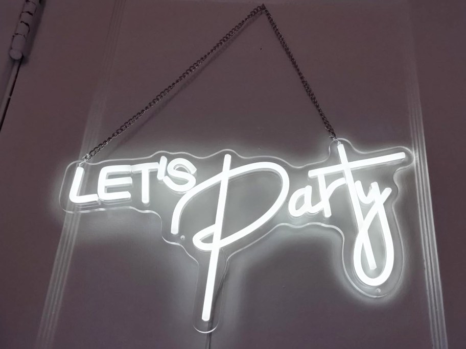 hanging led sign that says "let's party"