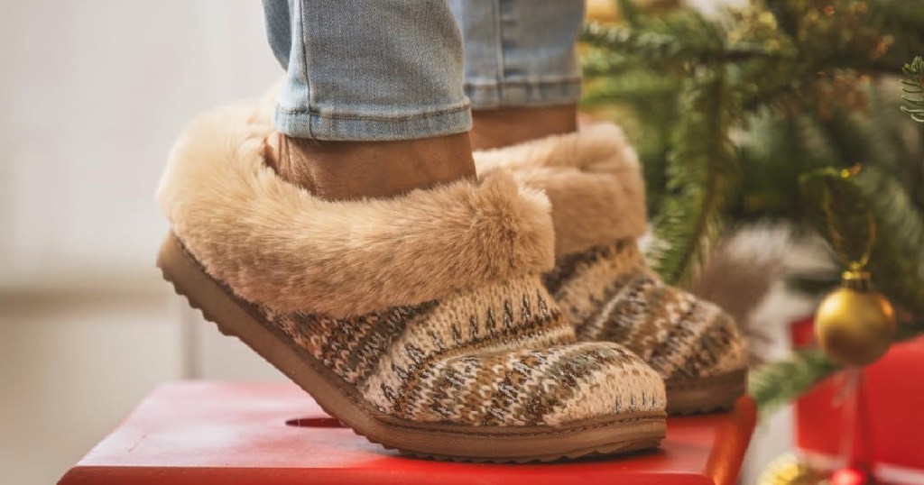 woman wearing Hannah Festive Knit Clogs and standing on red stool