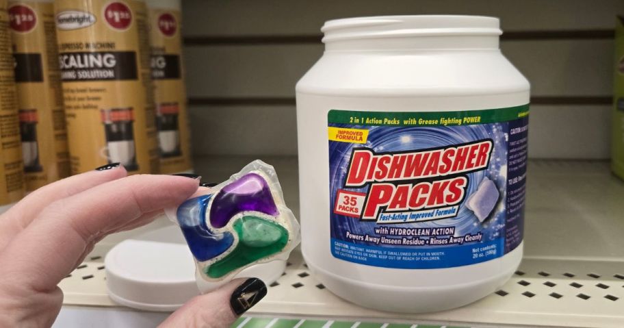 Dishwasher Packs 35-Count tub in store with had holding dishwasher pack in front of it