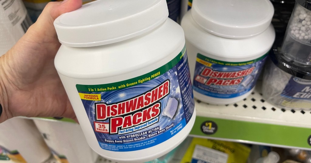 Woman holding container of dishwasher packs inside Dollar General store