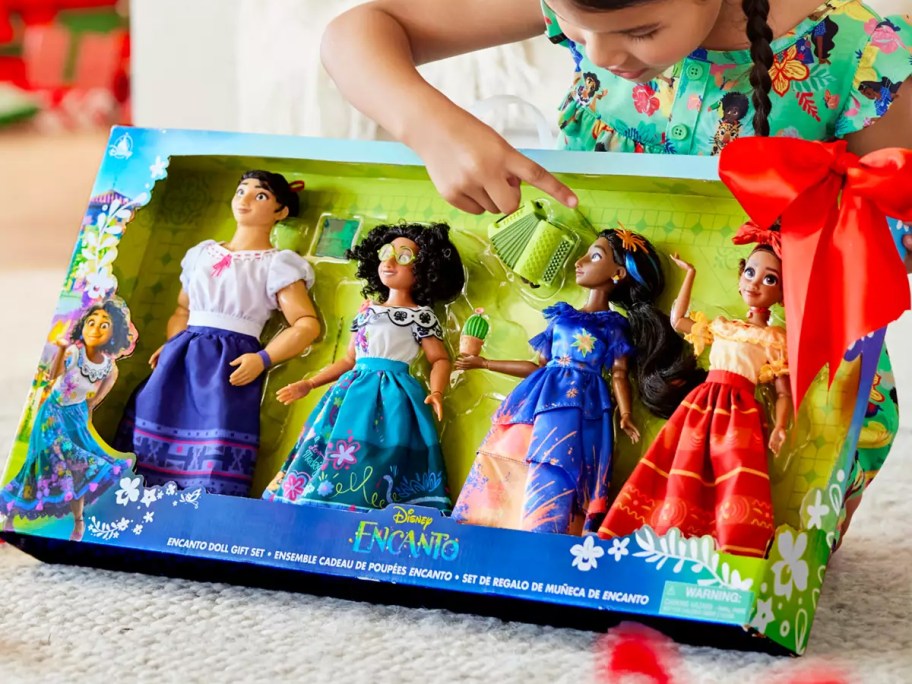 girl unwrapping a Disney Encanto 11" Doll Gift Set