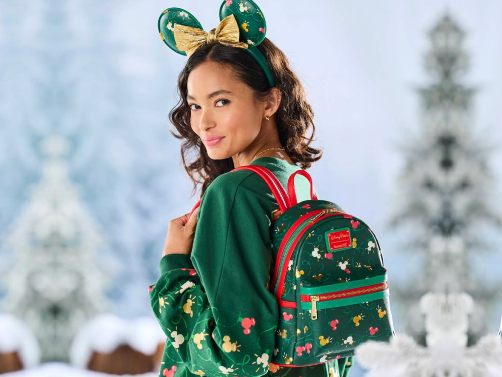 girl with mickey ears wearing Disney Loungefly Mickey Mouse Holiday Lights Mini Backpack outside