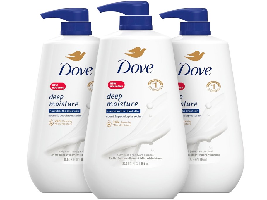 three large white and blue bottles of dove body wash