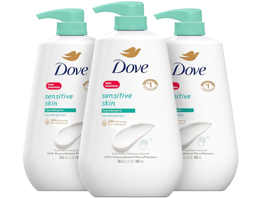 three large white and green bottles of dove body wash