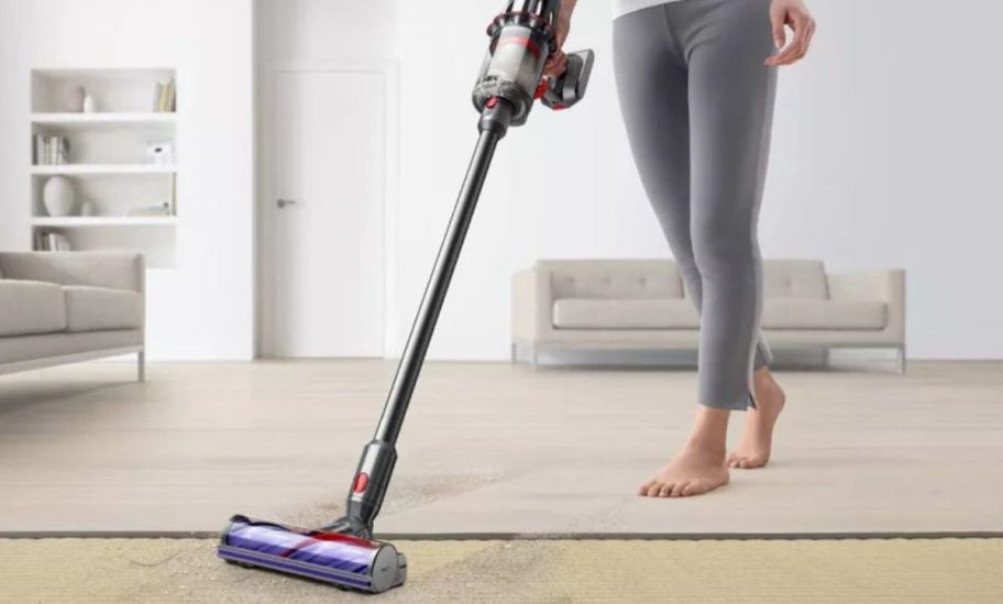 woman using Dyson Digital Slim Cordless Stick Vacuum