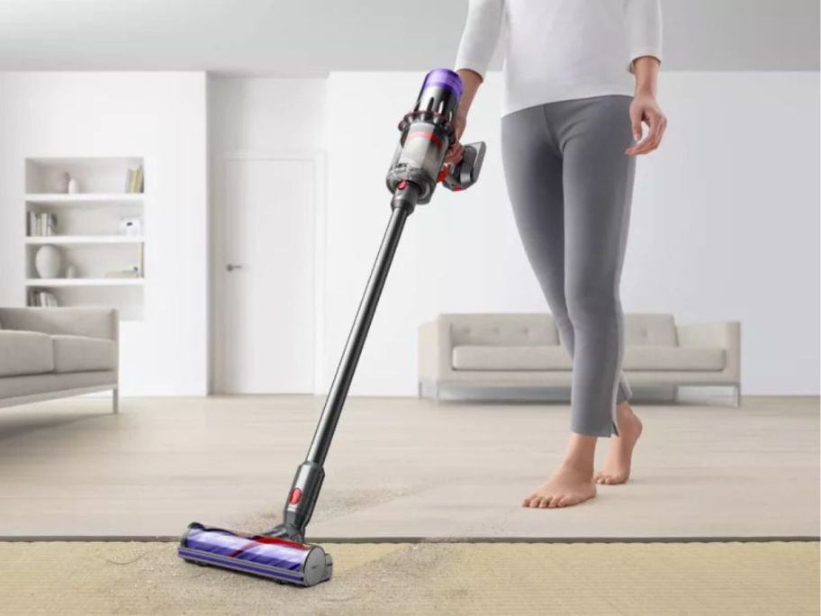 woman using Dyson Digital Slim Cordless Stick Vacuum