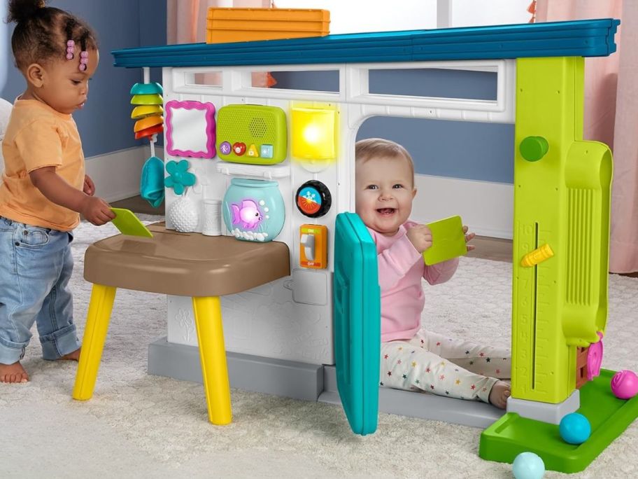 kids playing with Fisher-Price Laugh & Learn Ultimate Playhouse