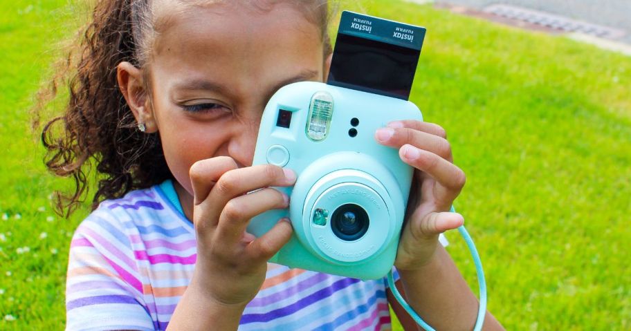 girl using Fujifilm Instax Mini 12 Instant Print Camera w/ Accessories