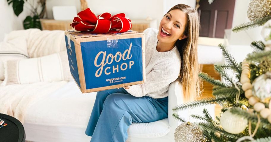 Woman holding a Good Chop Box with a big red bow on it