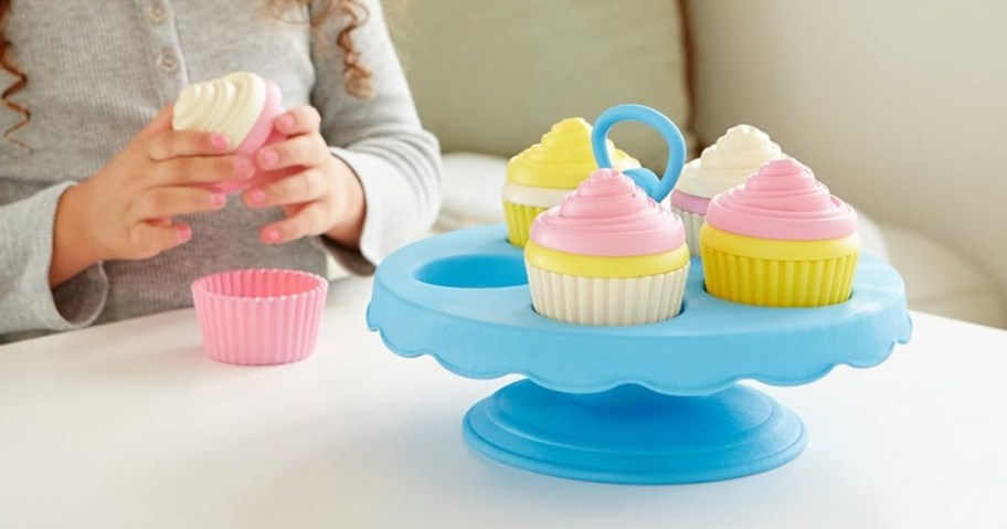 child playing with Green Toys 16-Piece Cupcake Set