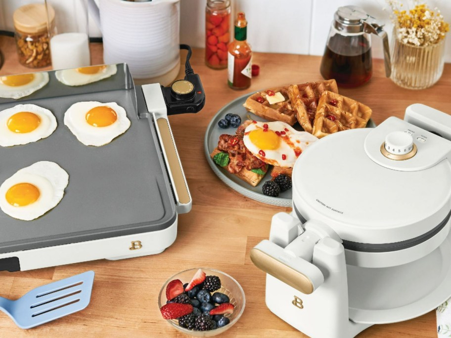 Griddle and waffle makeer displayed with food next to it