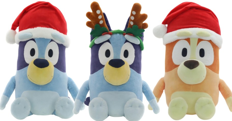 2 large Bluey plush animals, one is wearing a Santa hat, one is wearing reindeer ears, and there is a large Bingo wearing a Santa hat