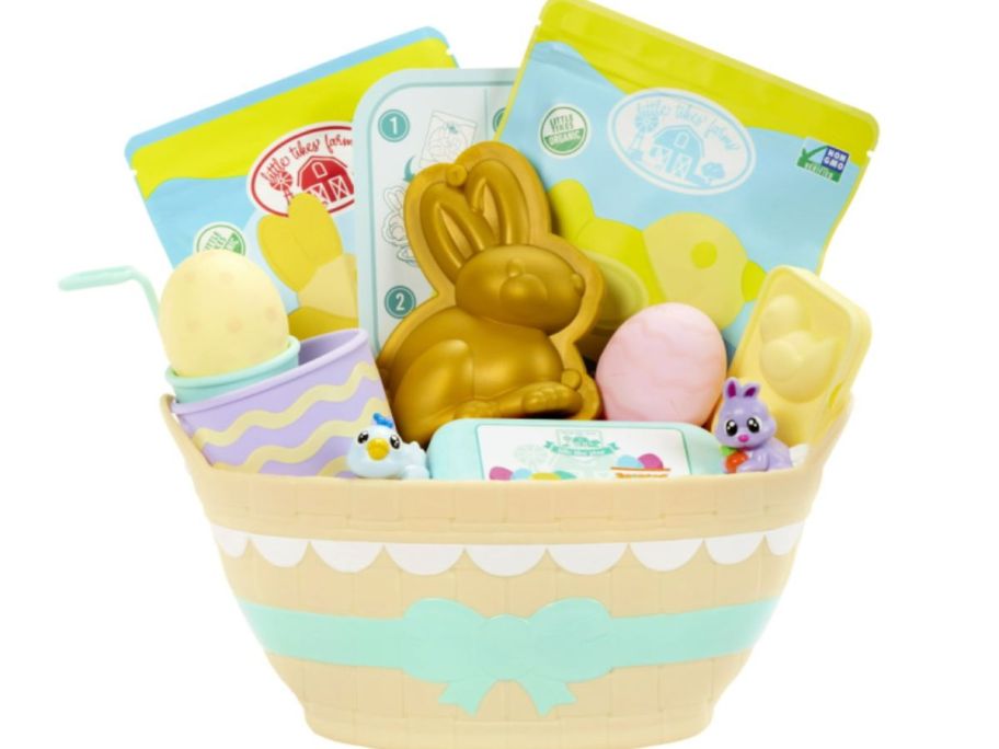 a tan Easter basket with various Easter egg dying and baking supplies for kids