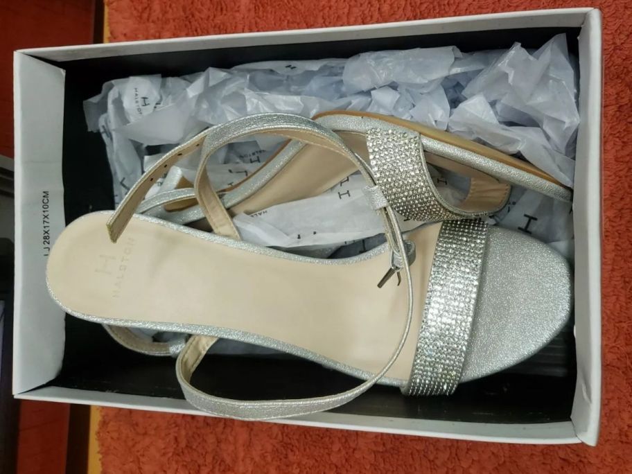 A pair of silver heels in a box