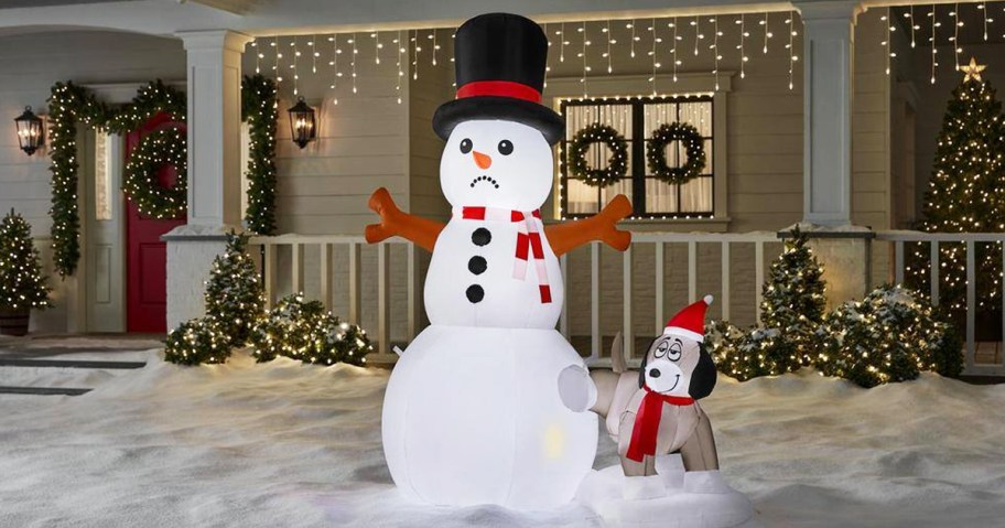 dog peeing on snowman inflatable