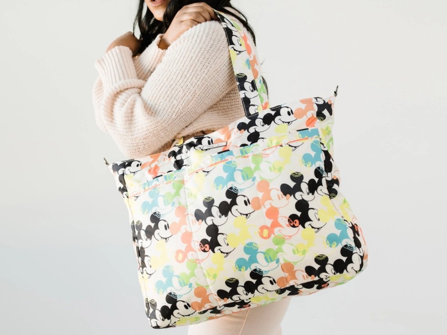 woman wearing jujube mickey mouse tote bag