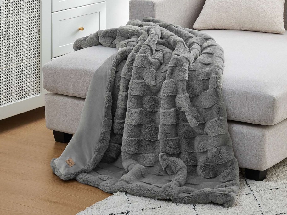 grey checkered throw blanket draped over a couch