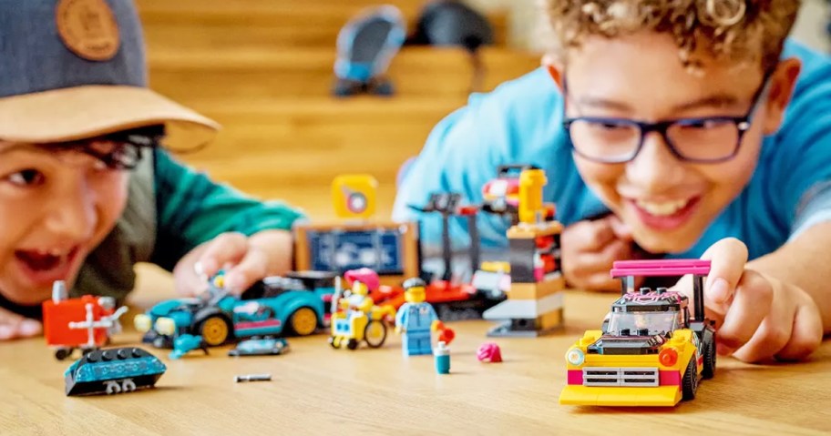 two boys playing with LEGO City Custom Car Garage set