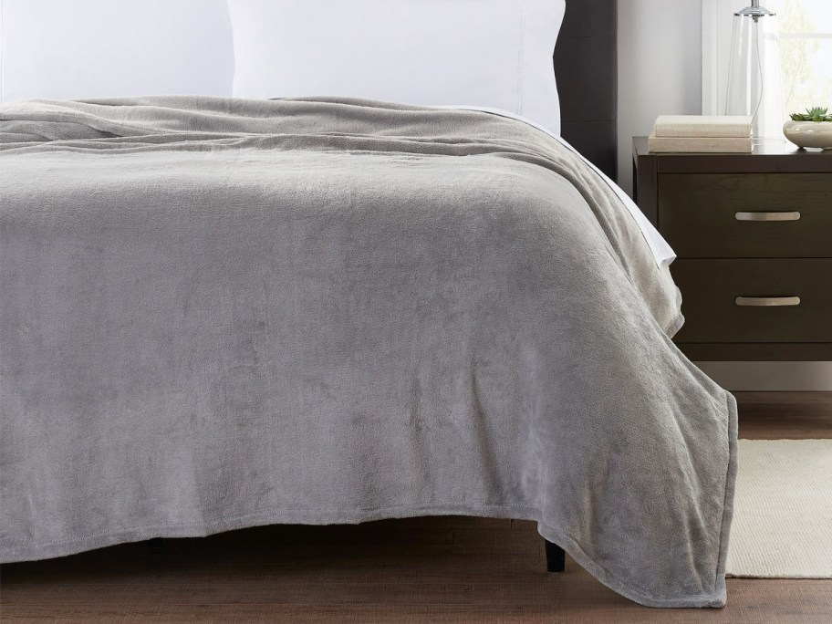 grey blanket on a bed