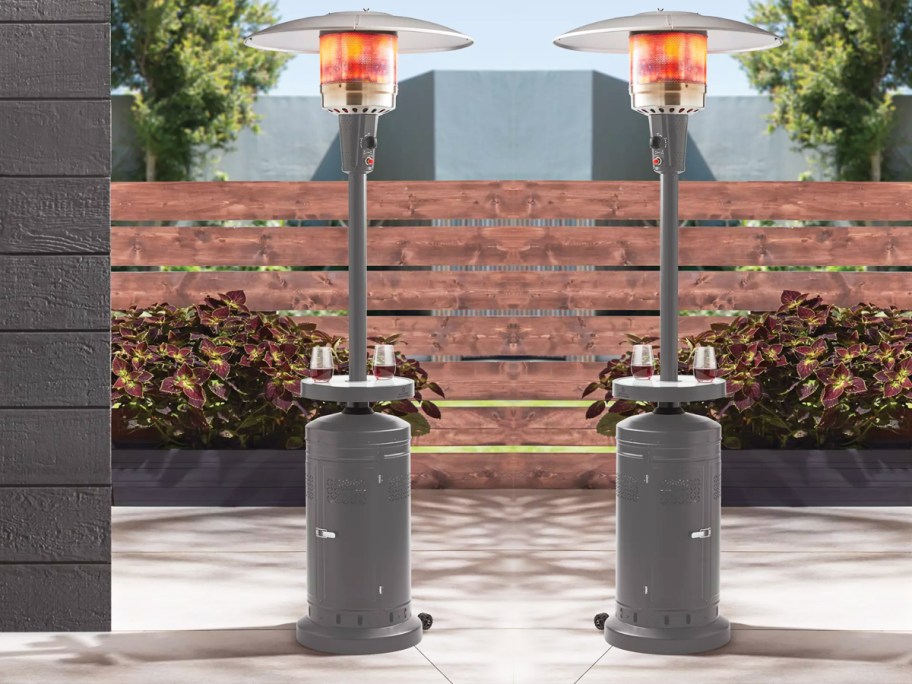 propane patio heaters with tables holding drinks