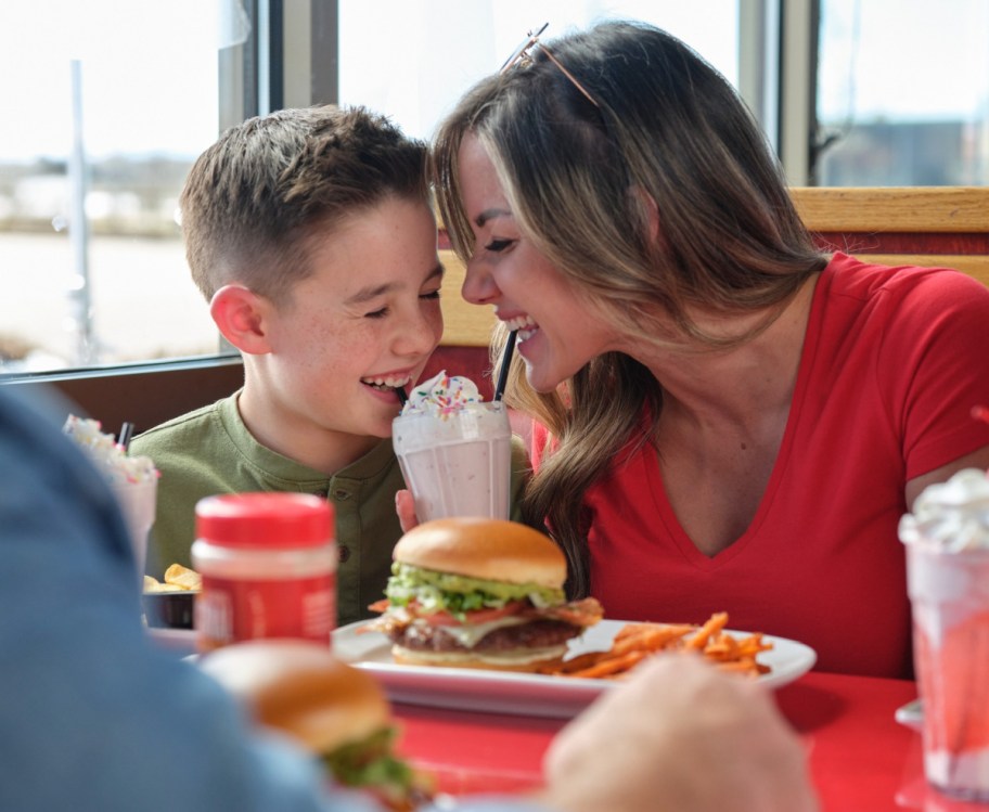 Mom and son eating at red robin where kids eat free